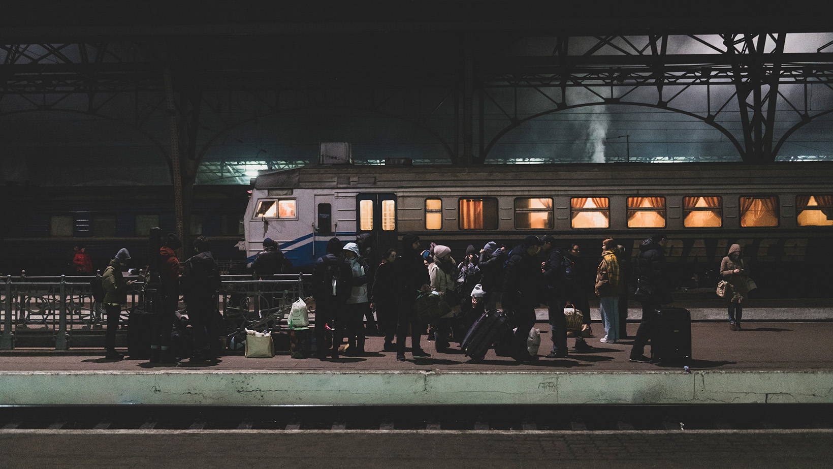 People on a train platform in Lwiw, Ukraine