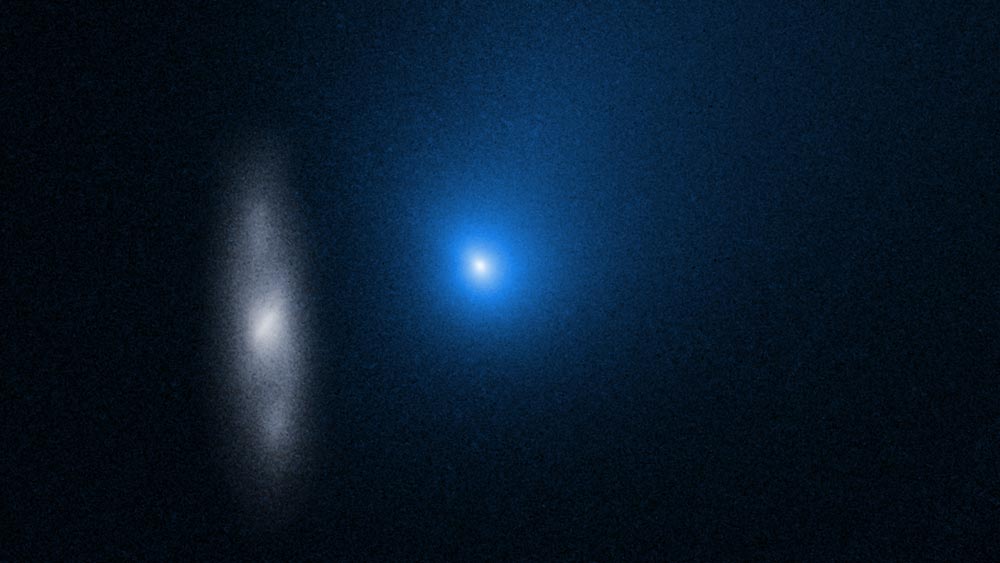 A bright blue light sits on a dark black background near a faint outline of the galaxy 